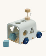 The PlanToys Sorting Bus Orchard, is a fun push-pull shape sorter toy for little ones. The bus is a light blue colour, with dark blue wheels and comes with colourful blocks to push through the cut out holes, offering and fun and sensory experience for kids. The image is on a cream background