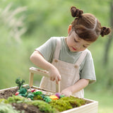 Child building planting beds using pieces from PlanToys stack and sprout set on a large planter