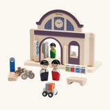 PlanToys wooden train station compatible with a a rail set. Features wooden people figures 