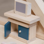 The TV and TV display unit from the PlanToys Living Room Dolls House Furniture Set shown in place in a wooden dolls house. 