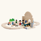 A railroad setup using PlanToys rail pieces and a train station