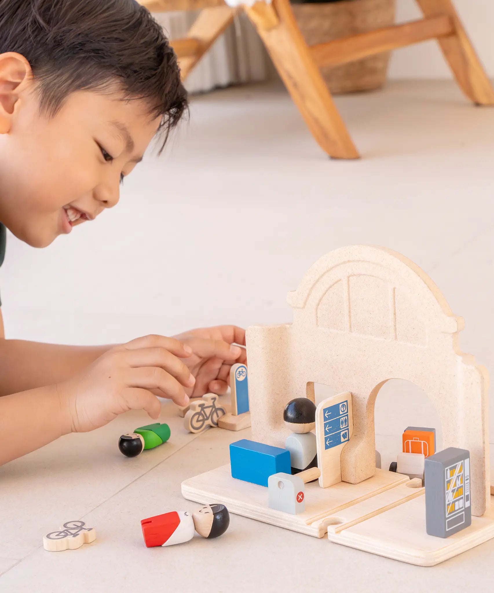 Back of a PlanToys wooden train station expansion set