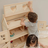 Child lifting the working roof showing the attic on the PlanToys Victorian dolls 