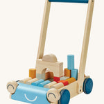 Plan toys eco-friendly wooden baby walker in the orchard colour, is a fun 2 in 1 toy with a blue and natural wood walker, and also comes with colour and natural wooden blocks. The image is on a cream background