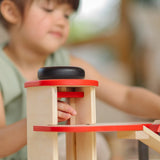 PlanToys wooden city parking garage showing a close up of the winding lift