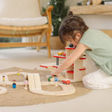 Child playing with a vehicles and the carpark from the PlanTous city transit rail and road playset