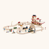 A city play setup made from PlanToys wooden rail and road pieces, train station and a carpark. 