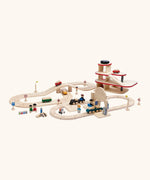 A city play setup made from PlanToys wooden rail and road pieces, train station and a carpark. 