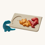 PlanToys Kids Dinosaur Puzzle, comes with 3 adorable dinosaurs in blue, yellow and red and a light coloured puzzle base on a cream background