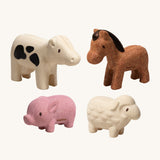 The PlanToys Farm Animals Set come with four adorable figures which include a pink pig, a white cow with black spots, a brown horse and a white sheep. The image is on a cream background