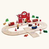 PlanToys fire & rescue roadway set. Showing wooden road pieces in a ring, emergency vehicles and figures and a fire station