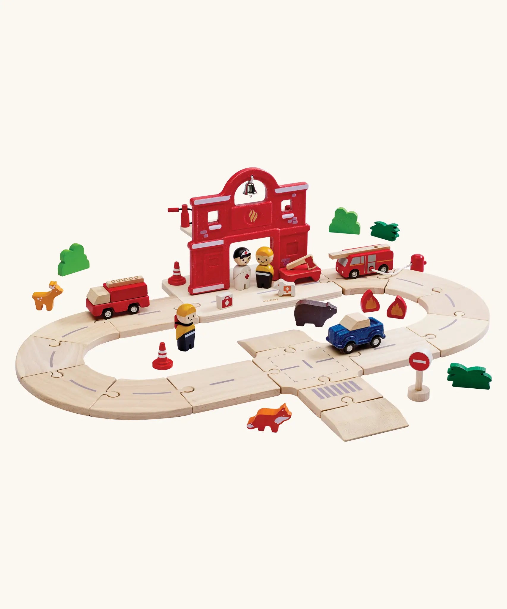 PlanToys fire & rescue roadway set. Showing wooden road pieces in a ring, emergency vehicles and figures and a fire station