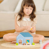 Child playing with the the PlanToys wooden blue house set 