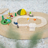 PlanToys wooden jungle explorers road playset on a rug  showing vehicles, tent, woodland animal figures