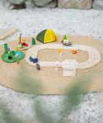 PlanToys wooden jungle explorers road playset on a rug  showing vehicles, tent, woodland animal figures