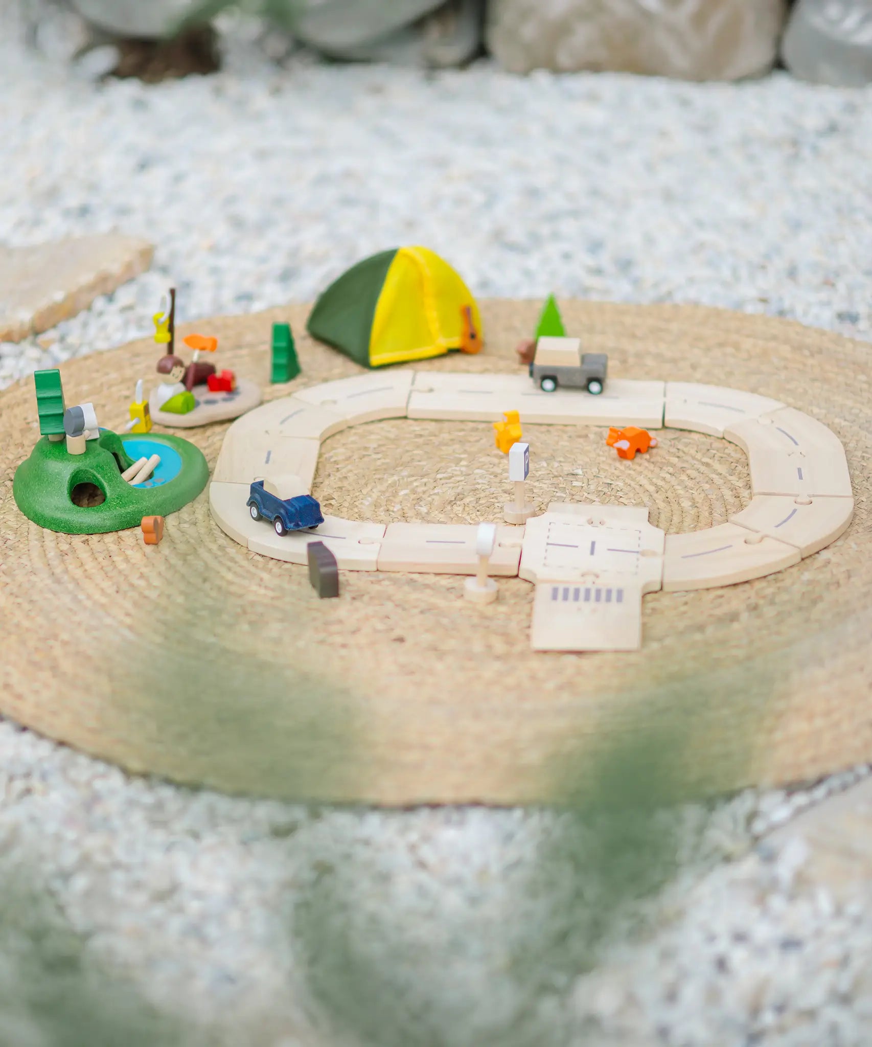 PlanToys wooden jungle explorers road playset on a rug  showing vehicles, tent, woodland animal figures