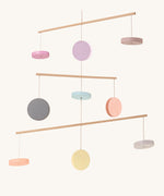 The PlanToys Mobile is a beautiful addition to any bedroom or playroom. With 9 colourful wooden disks strung between 3 different levels, on a cream background