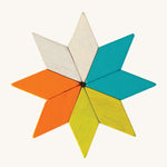 A star made from the shapes of the PlanToys Mini Mosaic Blocks, on a cream background