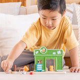 Child playing with a animal figure next to the PlanToys pet shop play set