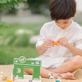 Child playing with the PlanToys pet shop play set outdoors