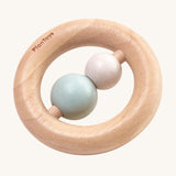The PlanToys Pastel Ring Rattle is a natural wood ring rattle, with 2 pastel coloured beads in the centre. This ring shape baby rattle is easy for little fingers to grasp, and the 2 beads give a satisfying rattle when shaken. The image is on a cream background