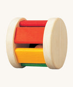 The PlanToys Pastel Roller, is a fun push and pull roller toy for babies and little ones. The roller comes with two natural wooden sides, with rainbow coloured slats, there is also a little wooden ball inside for an auditory experience too. The image is on a cream background