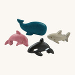 The PlanToys Sea Life Set comes with four adorable marine life figures which include a pink dolphin, a blue whale, a grey shark and a black and white orca. The image is on a cream background