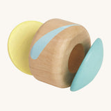 The PlanToys plastic-free, wooden clapping roller toy is a fun, sensory toy for babies and little ones. The clapper sides are in a soft blue and soft yellow colour, and the middle is natural wood with a light blue stripe. The image is on a cream background.