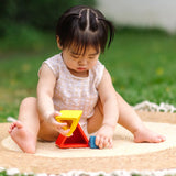 Child playing with the PlanToys nesting triangle wooden toy. 