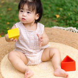Child playing with the PlanToys nesting triangle wooden toy. 