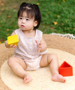 Child playing with the PlanToys nesting triangle wooden toy. 