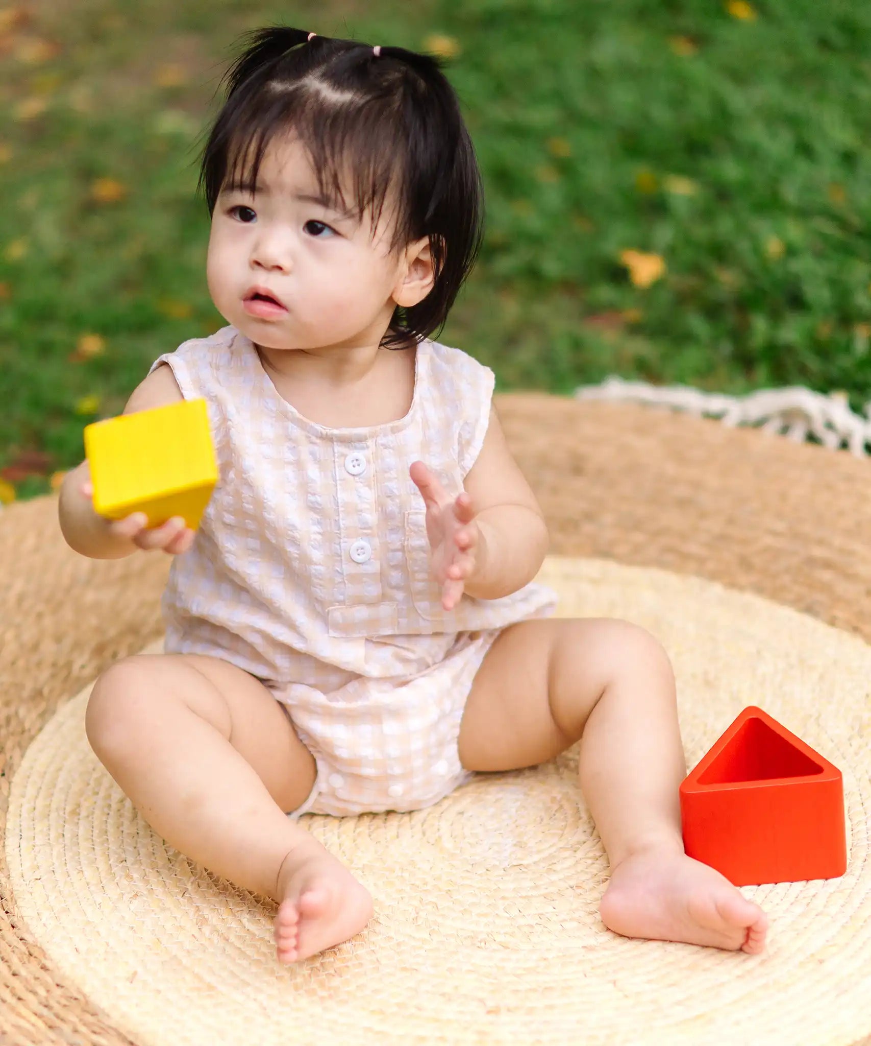 Child playing with the PlanToys nesting triangle wooden toy. 