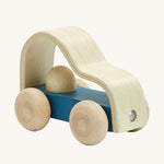 Plan toys childrens eco-friendly wooden vroom truck toy on a cream background