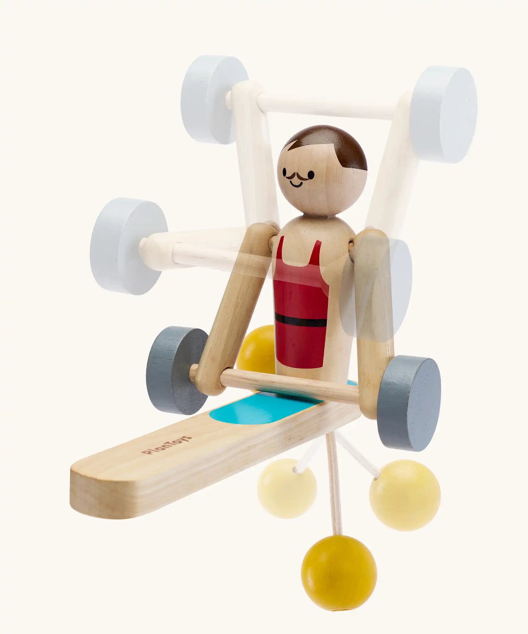 PlanToys Weightlifting Acrobat wooden toy shown with shadows of different movements overlaid on the photo.
