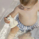 A child playing with the Oli & Carol Polar Bear Bath Toy Set in a bath