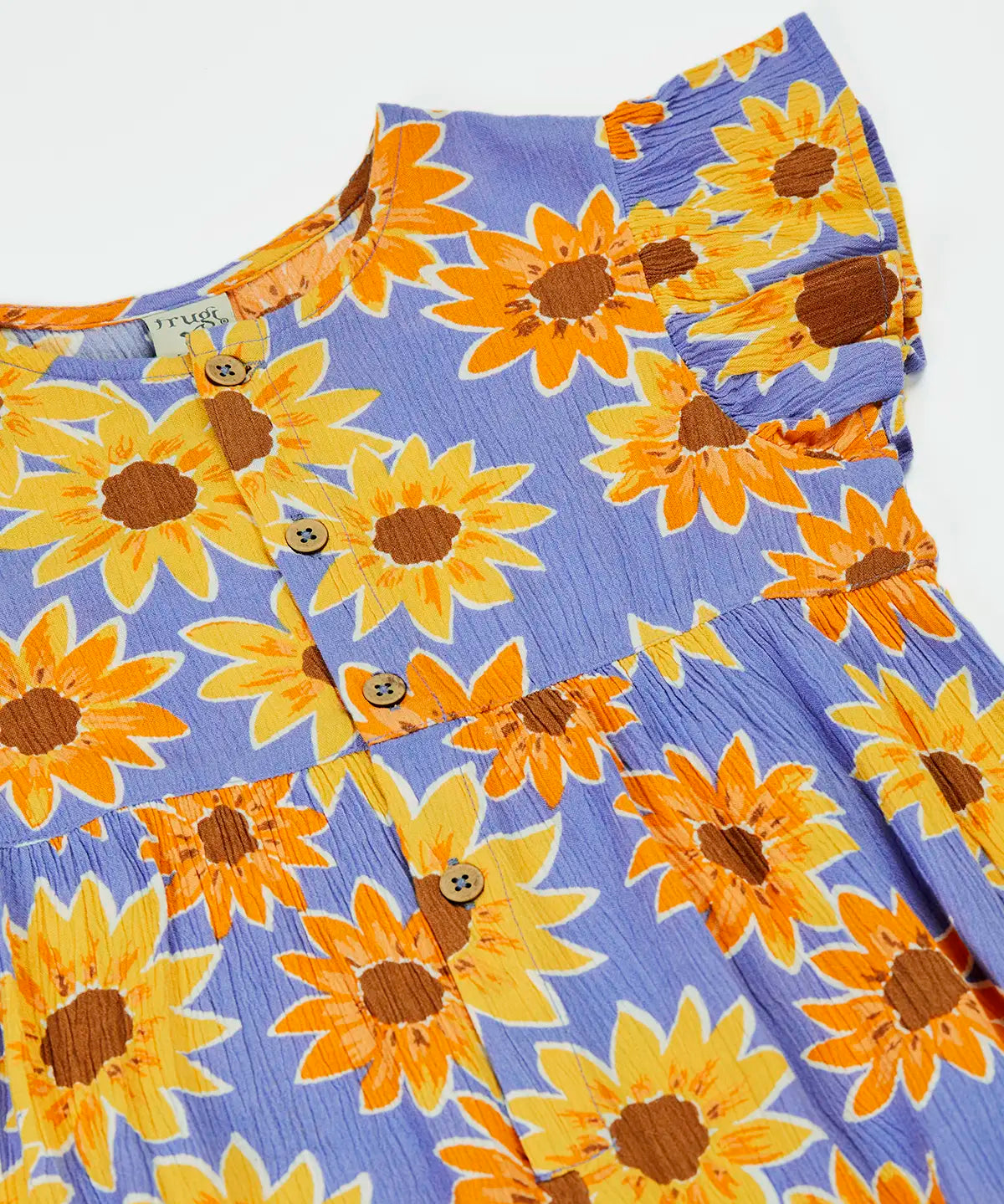 Frugi Lowenna jumpsuit in purple with a repeating sunflower print laid flat. Showing frilled shoulder and front button fasteners