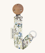 Avery Row Pacifier Holder - River Bank, showing the silicone ring and wooden clip