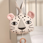 The Roommate Musical Baby Mobile - Leopard hung on the corner of a baby cot bed