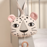 The Roommate Musical Baby Mobile - Leopard hung on the corner of a baby cot bed
