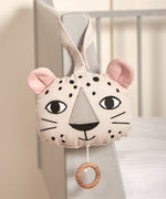 The Roommate Musical Baby Mobile - Leopard hung on the corner of a baby cot bed