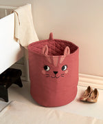 Large Roommate organic cotton storage cat basket in red standing in a bedroom 