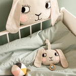 Roommate Musical Baby Mobile - Bunny and Roommate Bunny cushion in a baby bed