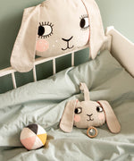 Roommate Musical Baby Mobile - Bunny and Roommate Bunny cushion in a baby bed