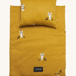 Roommate Doll Bedding Set - Tiger, in a mustard yellow colour, with adorable tiger print. The image shows a blanket and a pillow set on a cream background