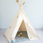 The Roommate Organic Cotton Bee Rattle Toy is laying inside a white Roommate tent with various Roommate toys, on a blue background