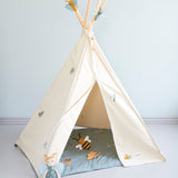 The Roommate Organic Cotton Bee Rattle Toy is laying inside a white Roommate tent with various Roommate toys, on a blue background