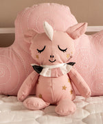 Roommate Canvas Doll Uni The Unicorn is propped up by a pink Roommate cloud cushion/pillow