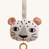 Roommate Musical Baby Mobile - Leopard, in the shape of a leopard face. Made from white fabric with black spots, two pink ears and a pull cord with a wooden hoop handle. On a cream background