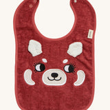 Roommate Organic Cotton Baby Bib - Red Panda, is a flannel style bib with a cute red panda face, interactive panda ears, and a metal popper fastener to close the bib behind the neck. The image is on a cream background
