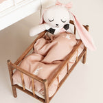 A closer look a the Roommate Doll Bedding Set - Rabbit, inside a dolls bed, with a Roommate Rabbit teddy